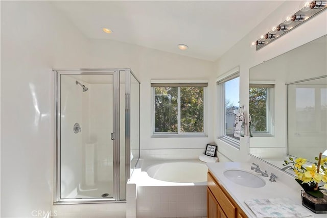 bathroom featuring lofted ceiling, vanity, and independent shower and bath