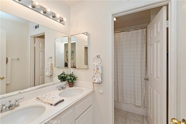 bathroom with shower / tub combo, tile patterned floors, and vanity