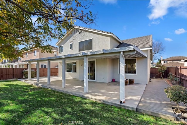 back of house with a yard and a patio area