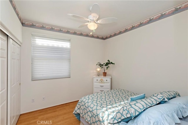 bedroom featuring a closet, ceiling fan, and light hardwood / wood-style flooring