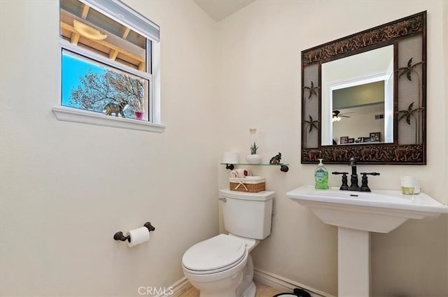 bathroom featuring toilet and ceiling fan