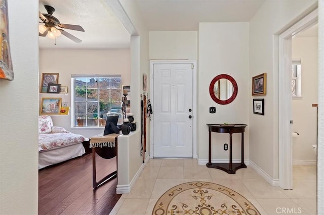 tiled entrance foyer with ceiling fan