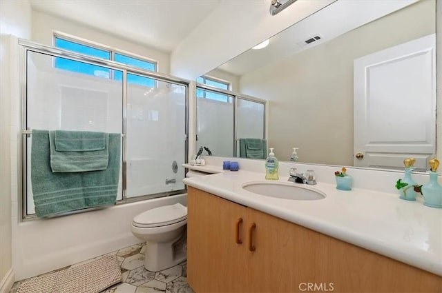 full bathroom with shower / bath combination with glass door, toilet, tile patterned floors, and vanity