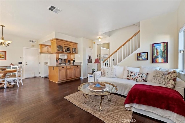 living room with an inviting chandelier and dark hardwood / wood-style flooring