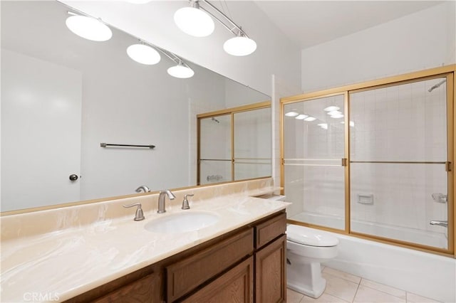 full bathroom featuring tile patterned flooring, bath / shower combo with glass door, vanity, and toilet