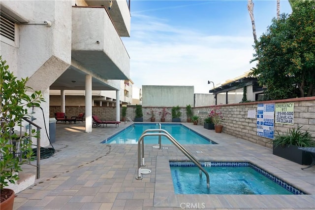 view of pool with a community hot tub and a patio