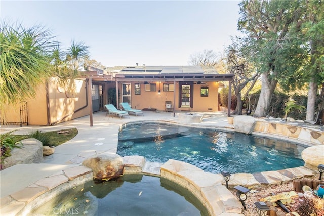 view of pool featuring a patio and a pool with connected hot tub