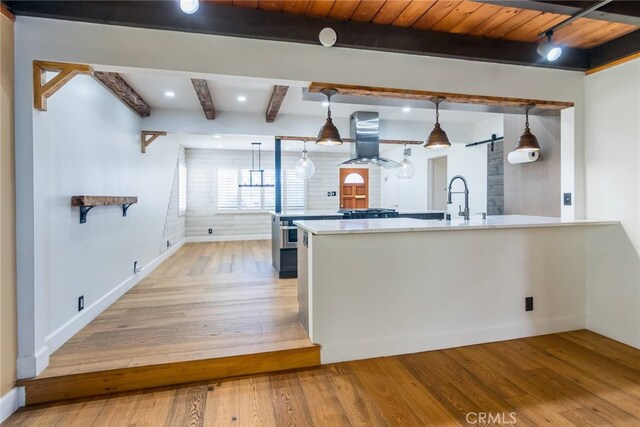 kitchen with island exhaust hood, wooden ceiling, hanging light fixtures, light wood-type flooring, and beam ceiling