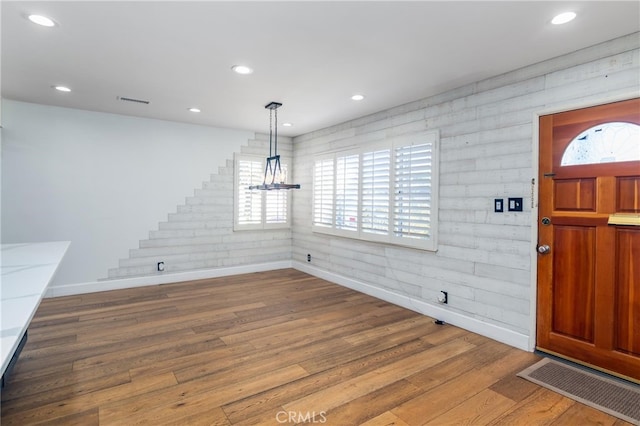 foyer with recessed lighting, baseboards, and wood finished floors