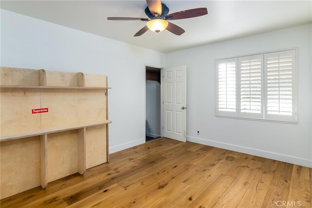 interior space with ceiling fan and wood-type flooring