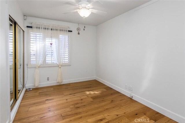 empty room featuring ceiling fan and light hardwood / wood-style floors