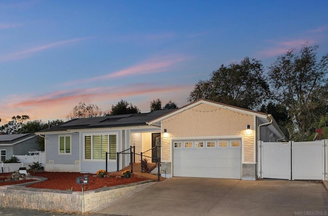 ranch-style home featuring solar panels and a garage