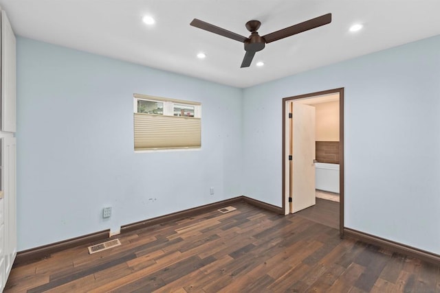 unfurnished bedroom with ceiling fan and dark wood-type flooring