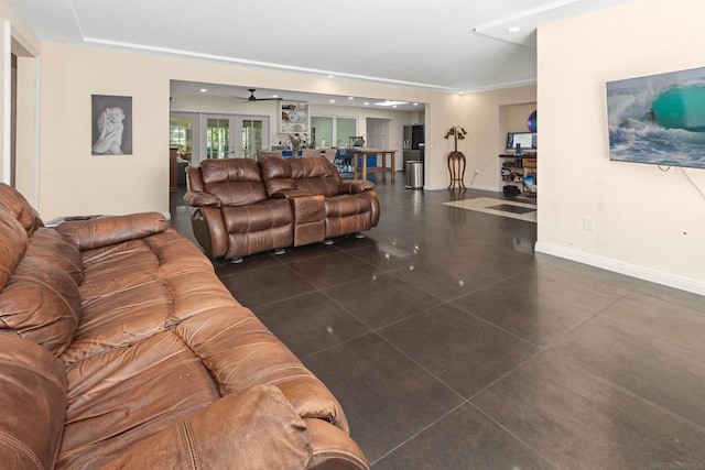 living room with ceiling fan, french doors, and dark tile patterned floors