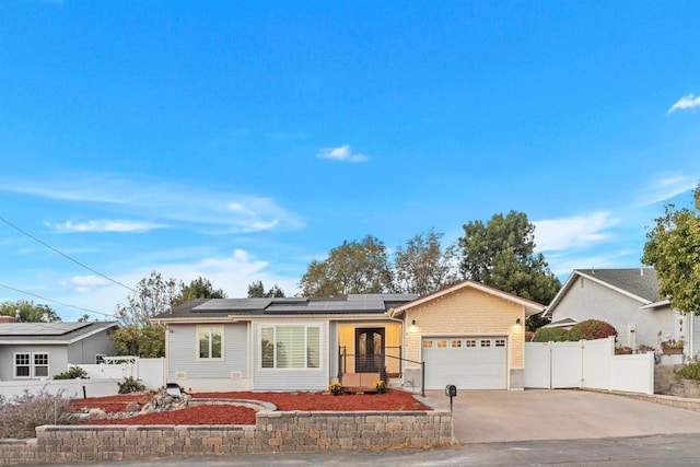 ranch-style house with solar panels and a garage