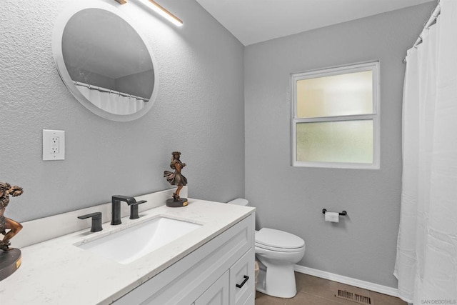 bathroom featuring toilet, vanity, and tile patterned floors