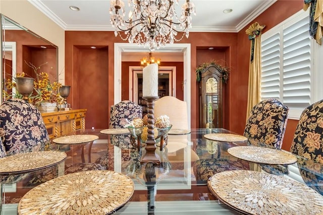 dining area with an inviting chandelier and ornamental molding