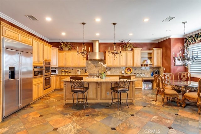650 Crystal Mountain Cir, Riverside, CA 92506 - kitchen featuring appliances with stainless steel finishes, wall chimney range hood, tasteful backsplash, light brown cabinetry, and recessed lighting
