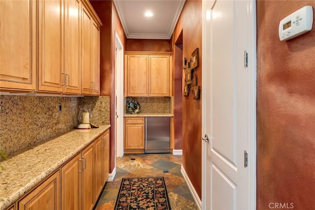 bar featuring light stone counters, decorative backsplash, ornamental molding, and refrigerator