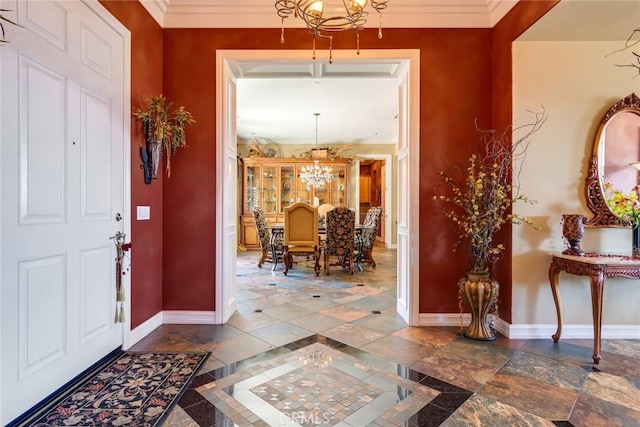 entryway with crown molding and a notable chandelier