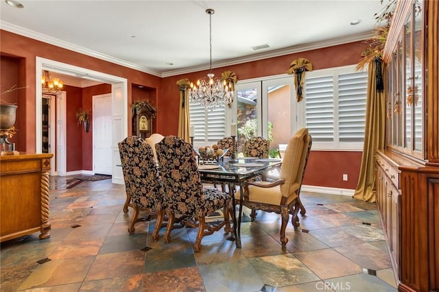 dining area featuring crown molding and an inviting chandelier