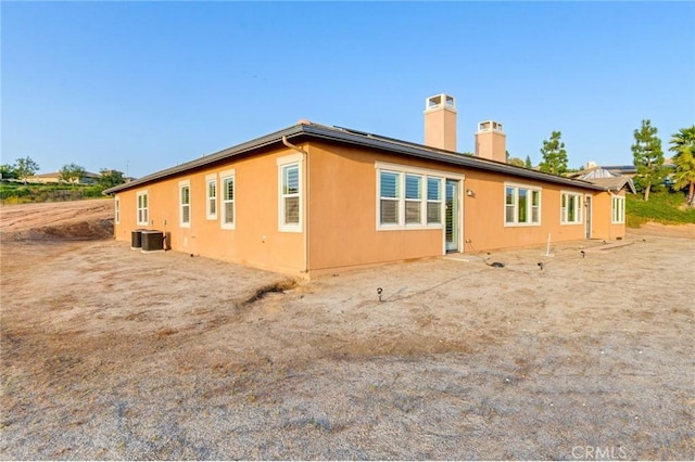 650 Crystal Mountain Cir, Riverside, CA 92506 - rear view of property with a chimney and central AC