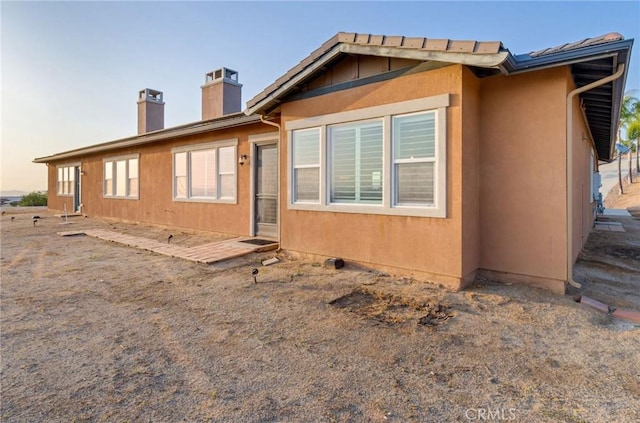650 Crystal Mountain Cir, Riverside, CA 92506 - rear view of property featuring a chimney and stucco siding