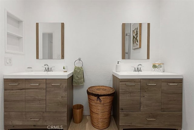 bathroom featuring built in shelves and vanity