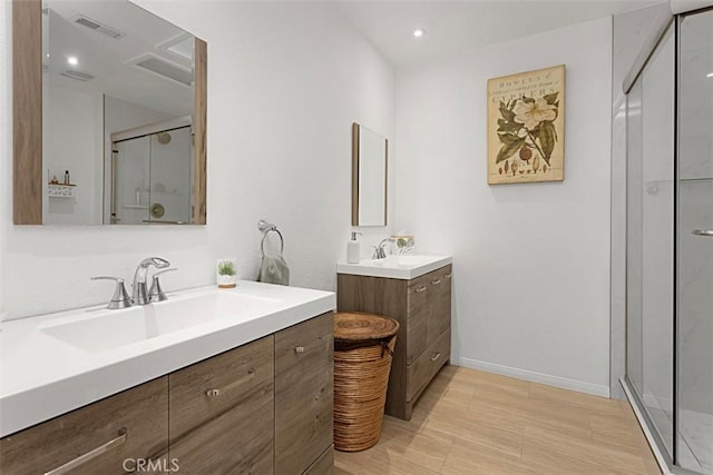 bathroom featuring vanity and a shower with door