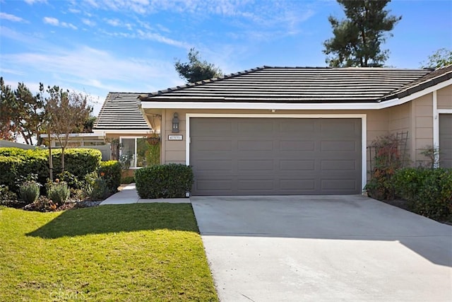 single story home with a front yard and a garage