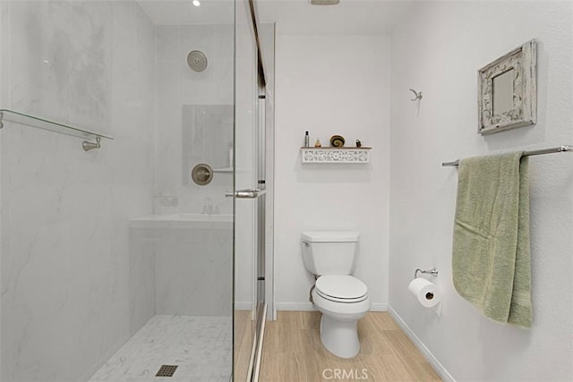 bathroom featuring walk in shower, toilet, and hardwood / wood-style flooring