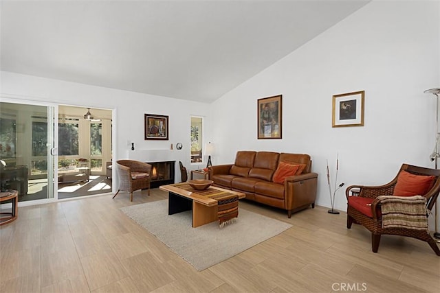 living room featuring vaulted ceiling and light wood-type flooring