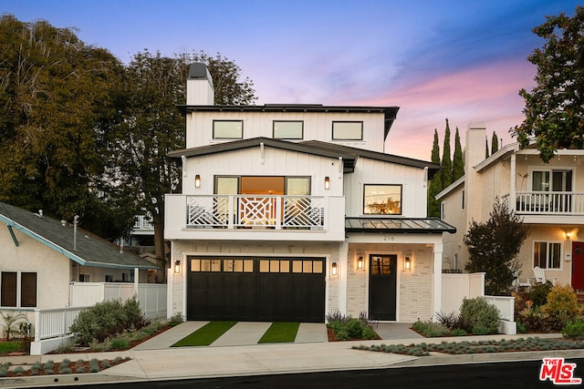 modern inspired farmhouse with a balcony and a garage