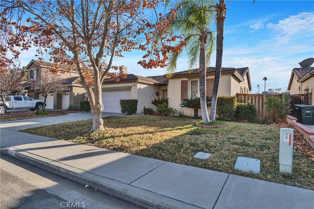 view of front of property featuring a front lawn and a garage