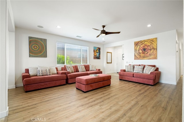 living room featuring ceiling fan and light hardwood / wood-style flooring