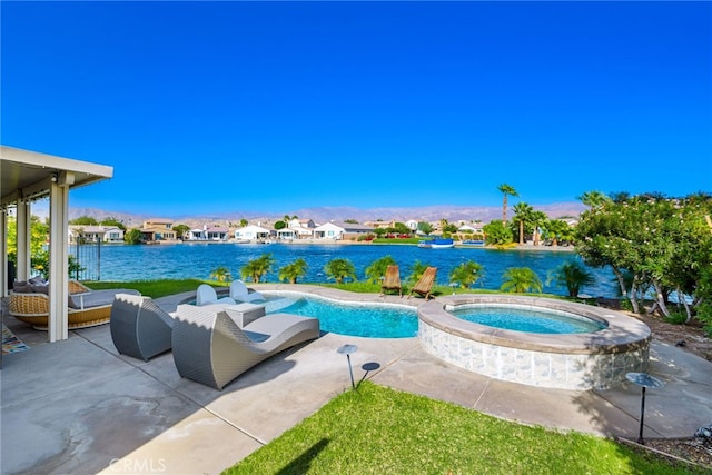 view of swimming pool with a patio area, an in ground hot tub, and a water view