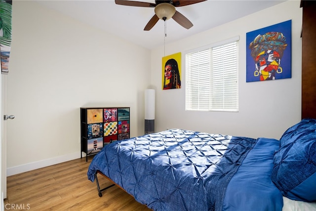 bedroom with ceiling fan and wood-type flooring