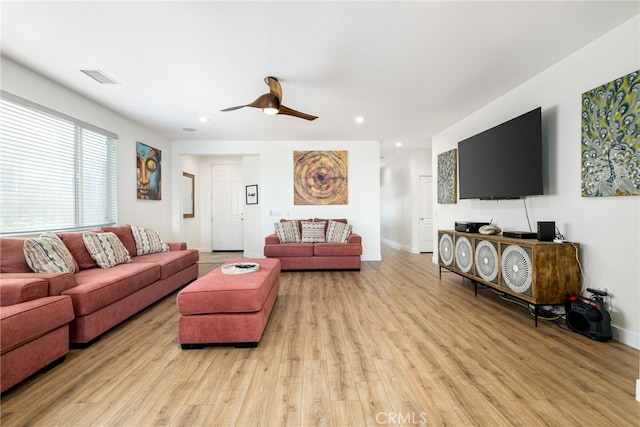 living room with ceiling fan and light wood-type flooring