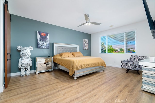 bedroom with ceiling fan and light hardwood / wood-style flooring