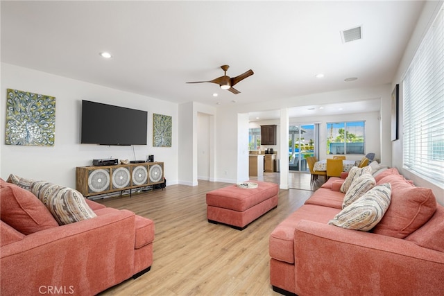 living room featuring light hardwood / wood-style floors and ceiling fan