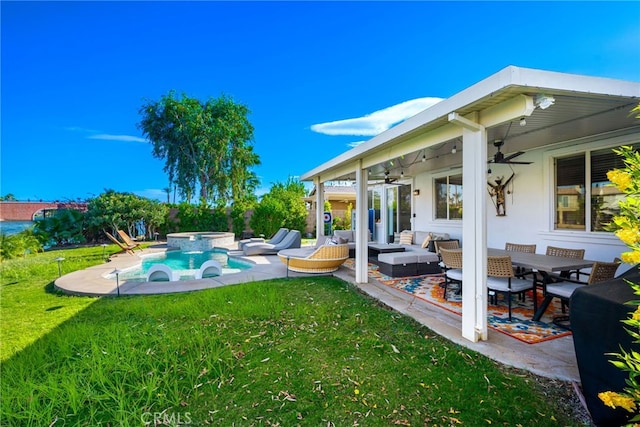 view of swimming pool with a yard, an in ground hot tub, ceiling fan, outdoor lounge area, and a patio area