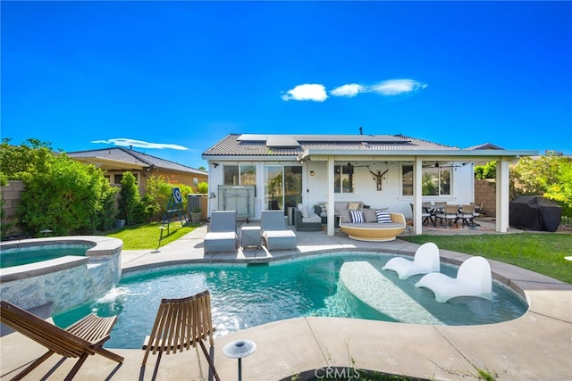 rear view of property with a pool with hot tub, a patio area, ceiling fan, and pool water feature