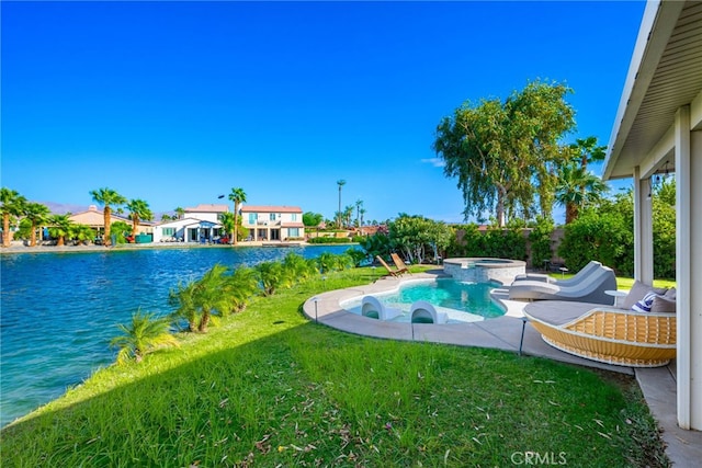 view of pool with a yard, an in ground hot tub, and a water view