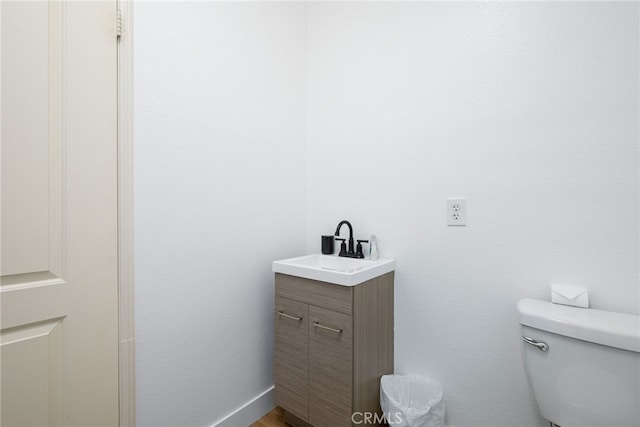 bathroom with toilet and vanity