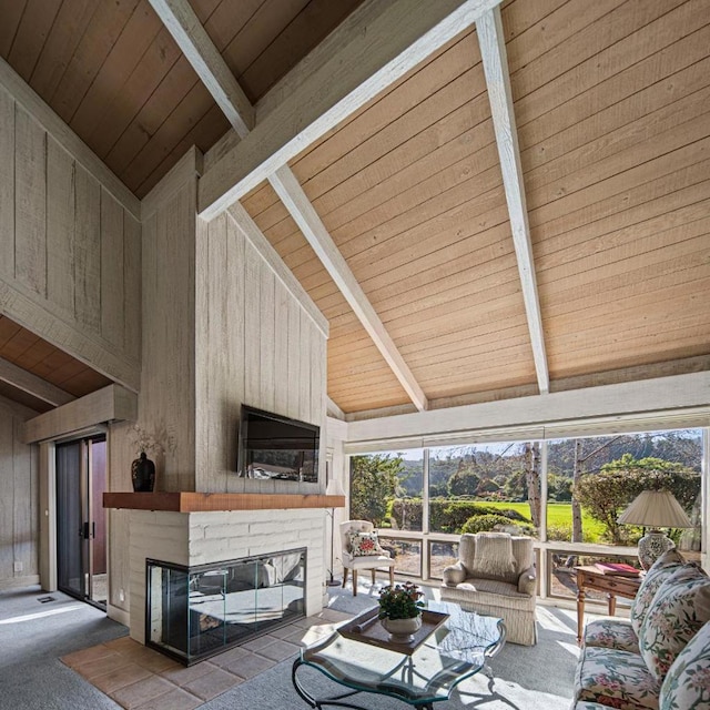 living room featuring wood walls, wood ceiling, high vaulted ceiling, a large fireplace, and beam ceiling