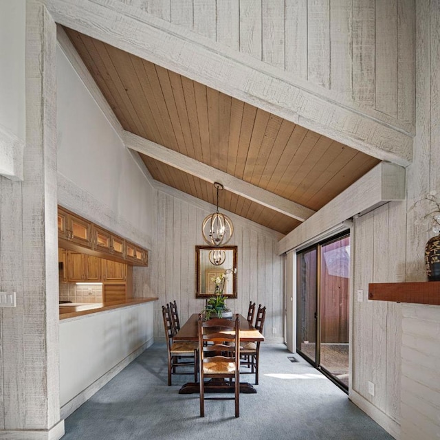 dining room with wood walls, lofted ceiling with beams, carpet floors, a notable chandelier, and wooden ceiling