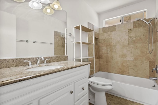 full bathroom featuring toilet, vanity, tile patterned flooring, and tiled shower / bath combo