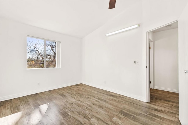 unfurnished room featuring lofted ceiling, wood-type flooring, and ceiling fan