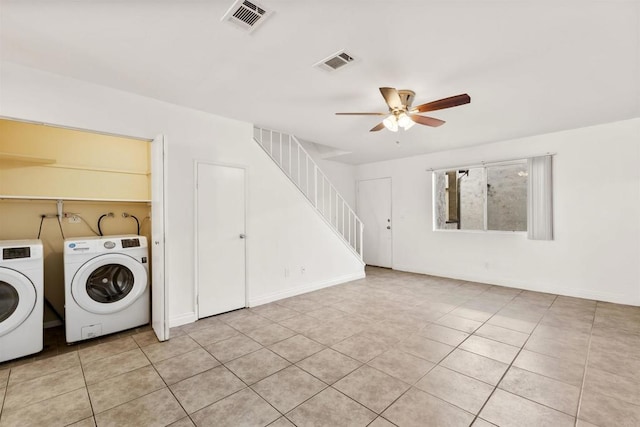 clothes washing area featuring washing machine and dryer, ceiling fan, and light tile patterned floors