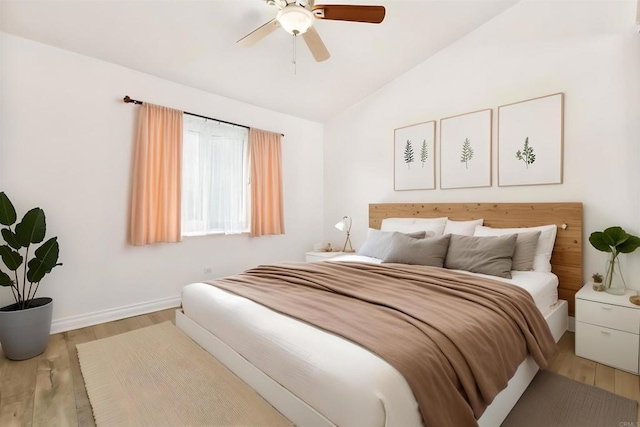 bedroom with vaulted ceiling, ceiling fan, and light hardwood / wood-style floors